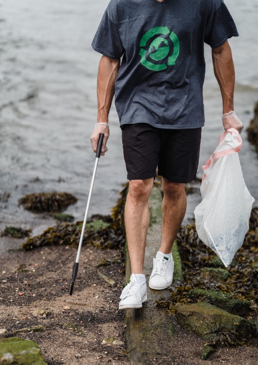 Man walking picking up trash