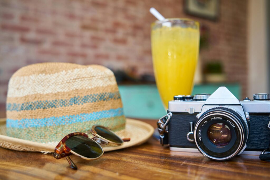 sunglasses, hat, camera and drink vacation